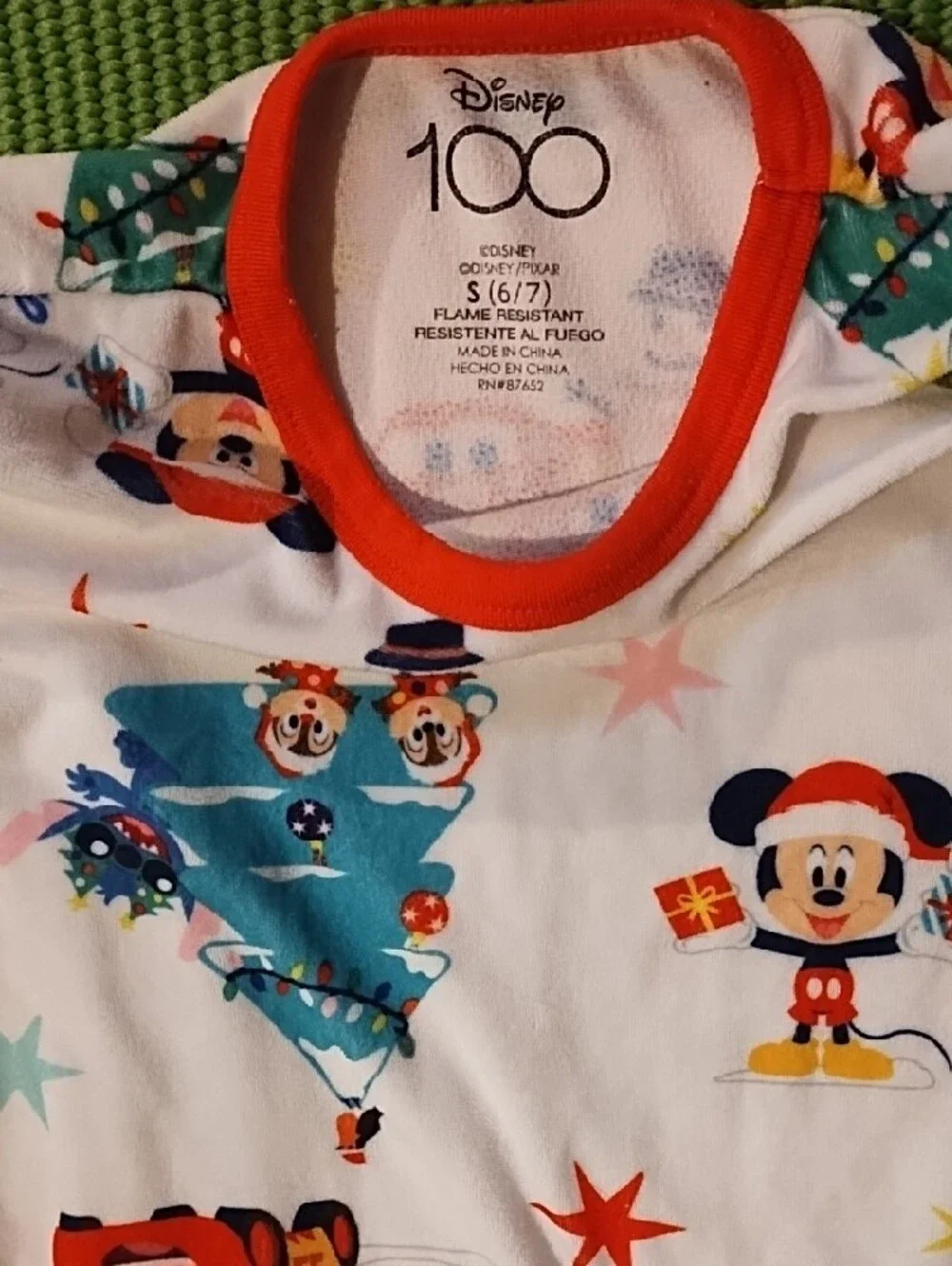 Disney Kids Holiday Pajama Set - White with Red Accents and Multicolor Prints.